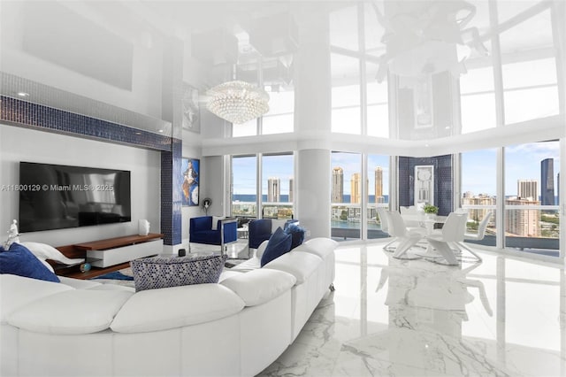 2600 Island Blvd Unit 2603, Aventura, FL 33160 - living room featuring a towering ceiling, a chandelier, a view of skyline, and marble tiled flooring