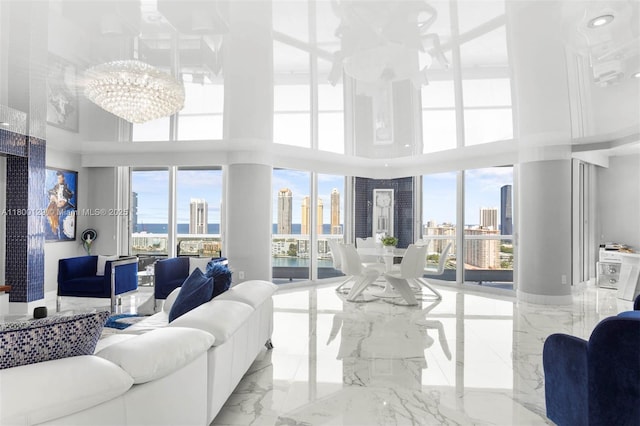 2600 Island Blvd Unit 2603, Aventura, FL 33160 - living area featuring a high ceiling, a chandelier, plenty of natural light, marble tiled flooring, and a view of skyline