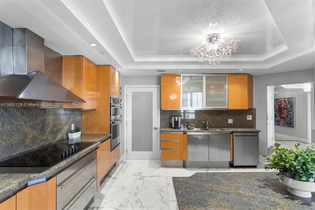 2600 Island Blvd Unit 2603, Aventura, FL 33160 - kitchen with appliances with stainless steel finishes, wall chimney range hood, light marble finish floors, a raised ceiling, and recessed lighting