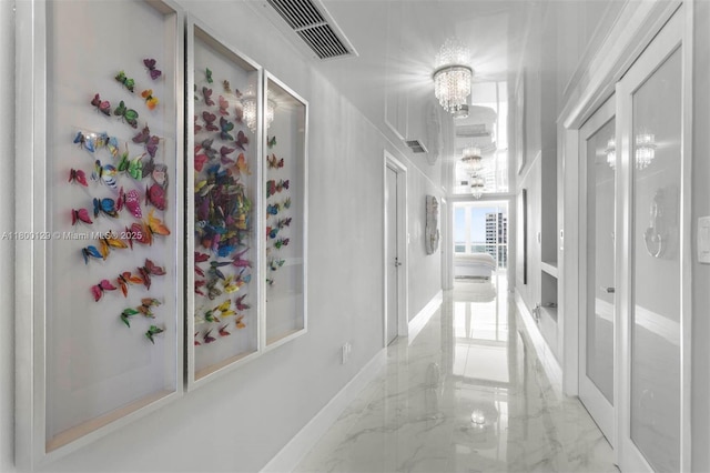 2600 Island Blvd Unit 2603, Aventura, FL 33160 - hall featuring light marble finish floors and a chandelier