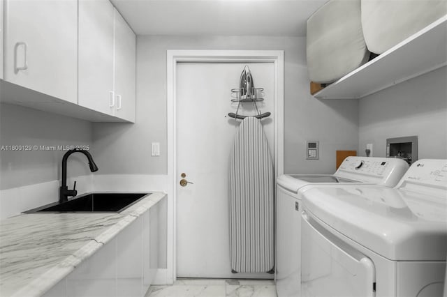 2600 Island Blvd Unit 2603, Aventura, FL 33160 - clothes washing area featuring washer and clothes dryer, cabinet space, and light marble finish flooring