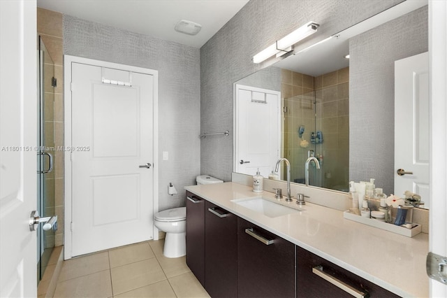 bathroom featuring tile patterned floors, a shower stall, vanity, and toilet