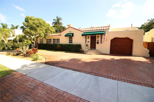 804 SE 10th St, Fort Lauderdale, FL 33316 - mediterranean / spanish-style home featuring decorative driveway, stucco siding, an attached garage, and a tiled roof