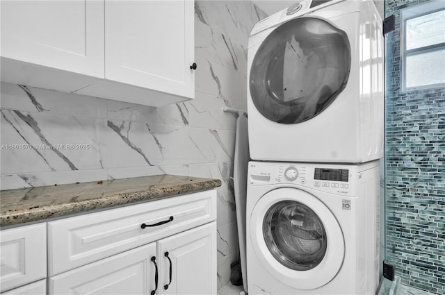 16750 NE 10th Ave Unit 314, North Miami Beach, FL 33162 - washroom featuring stacked washer / dryer and cabinet space
