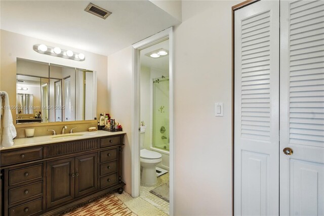 1100 Saint Charles Pl Unit 407, Pembroke Pines, FL 33026 - bathroom with toilet, vanity, a closet, and bath / shower combo with glass door