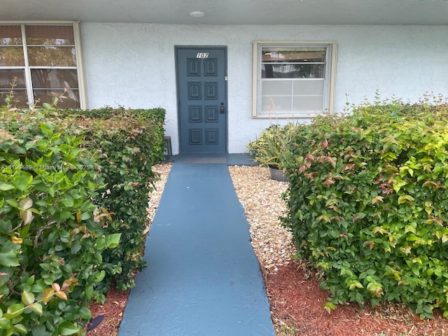 7680 NW 18th St Unit 107, Margate, FL 33063 - view of exterior entry featuring stucco siding