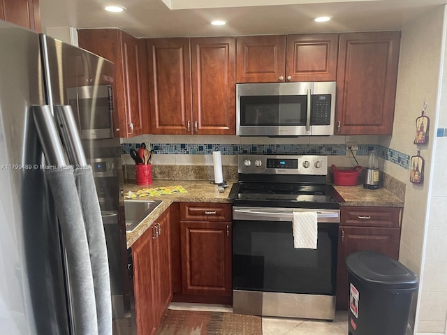 7680 NW 18th St Unit 107, Margate, FL 33063 - kitchen featuring stainless steel appliances, recessed lighting, light stone countertops, backsplash, and a sink