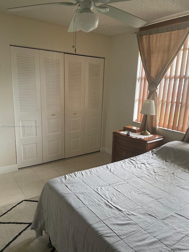 7680 NW 18th St Unit 107, Margate, FL 33063 - bedroom with tile patterned flooring, baseboards, a closet, and a ceiling fan