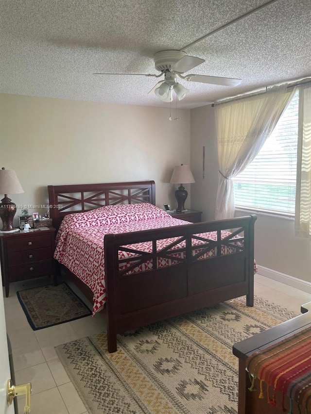 7680 NW 18th St Unit 107, Margate, FL 33063 - bedroom featuring a textured ceiling, ceiling fan, and tile patterned flooring