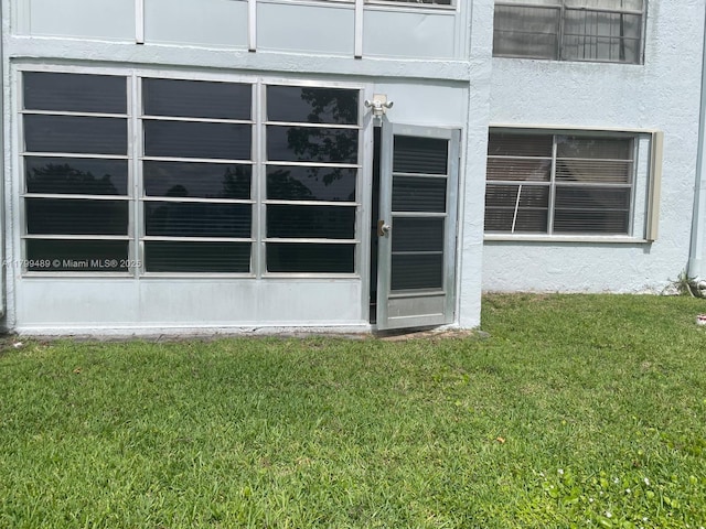 7680 NW 18th St Unit 107, Margate, FL 33063 - property entrance featuring a yard and stucco siding