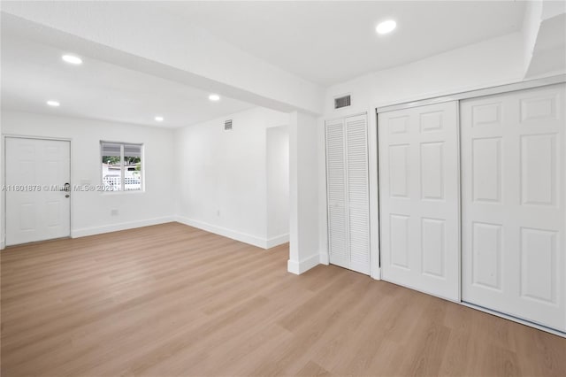 unfurnished bedroom featuring light wood-type flooring, recessed lighting, and baseboards
