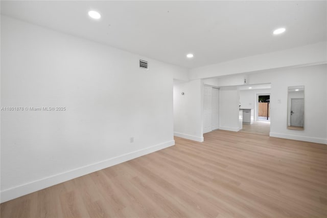 unfurnished living room with light wood finished floors, baseboards, and recessed lighting