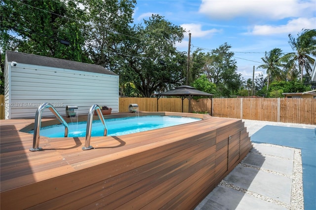 view of swimming pool featuring a fenced backyard and a wooden deck
