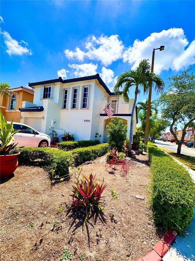 8686 SW 159th Path, Miami, FL 33193 - mediterranean / spanish-style home with stucco siding, a garage, and a tiled roof