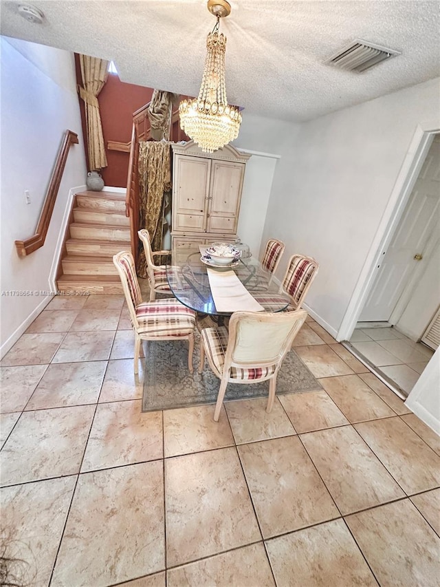8686 SW 159th Path, Miami, FL 33193 - dining space featuring stairway, a textured ceiling, a chandelier, light tile patterned flooring, and baseboards
