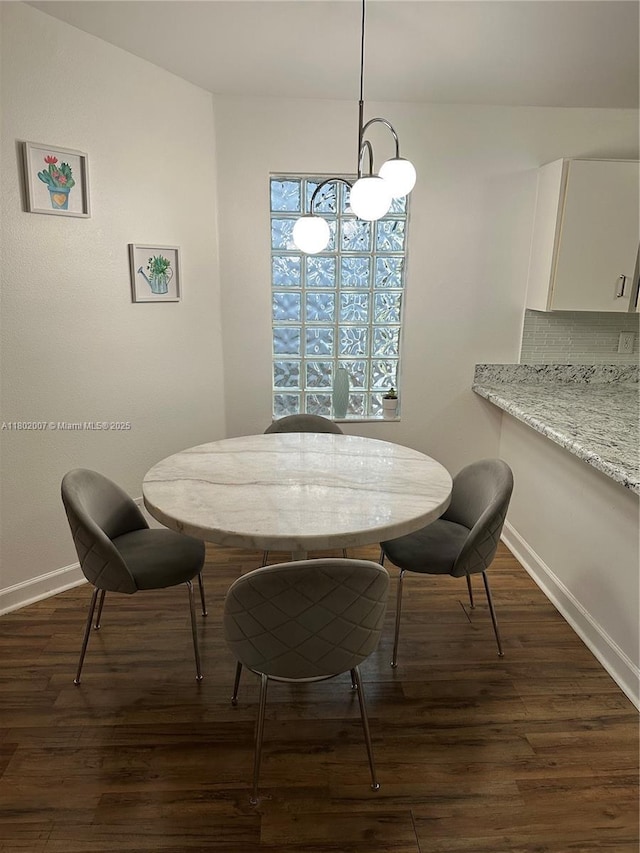 3828 NW 121st Ave, Sunrise, FL 33323 - dining space featuring baseboards, dark wood-style floors, and a chandelier