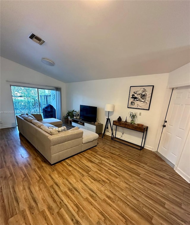 3828 NW 121st Ave, Sunrise, FL 33323 - living area featuring wood finished floors, lofted ceiling, and baseboards