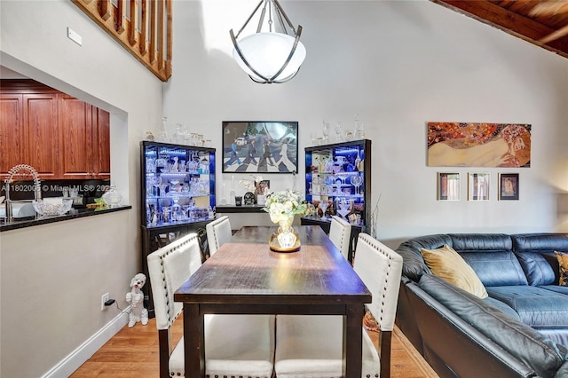 1951 SW 81st Ter, Davie, FL 33324 - dining space with light wood-style flooring, a high ceiling, and baseboards