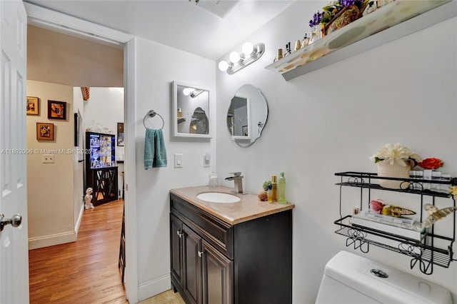 1951 SW 81st Ter, Davie, FL 33324 - bathroom featuring vanity, toilet, baseboards, and wood finished floors