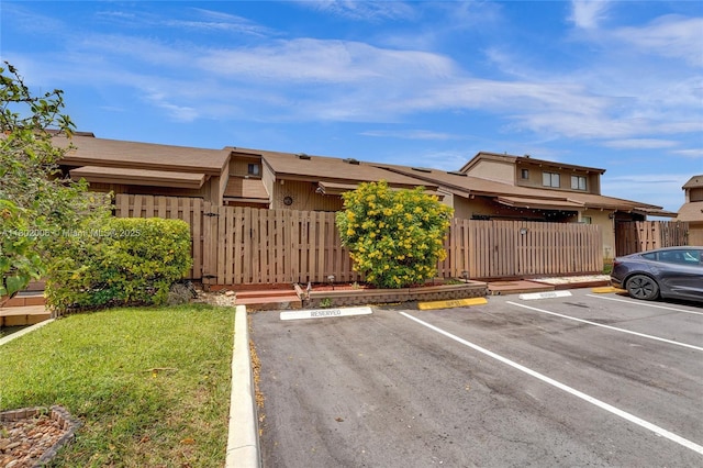 1951 SW 81st Ter, Davie, FL 33324 - view of front of house featuring uncovered parking, a fenced front yard, and a gate