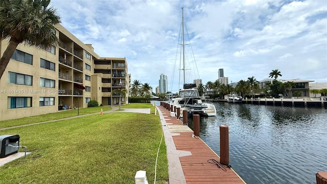 dock featuring a yard and a water view