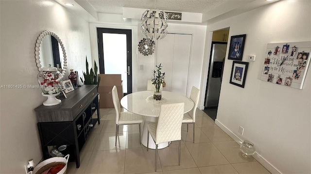 301 Golden Isles Dr Unit 203, Hallandale Beach, FL 33009 - dining area with light tile patterned flooring and a textured ceiling