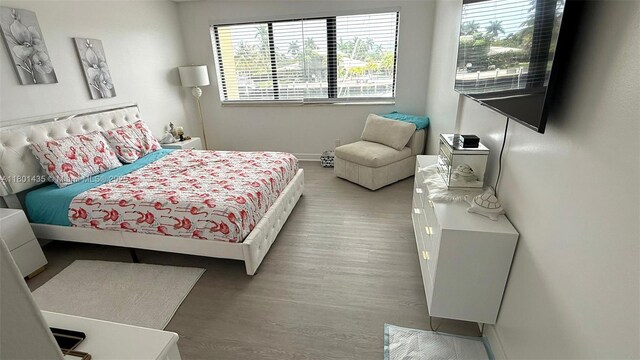 301 Golden Isles Dr Unit 203, Hallandale Beach, FL 33009 - bedroom with wood finished floors and baseboards