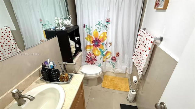 bathroom featuring tile patterned floors, shower / tub combo with curtain, toilet, and vanity