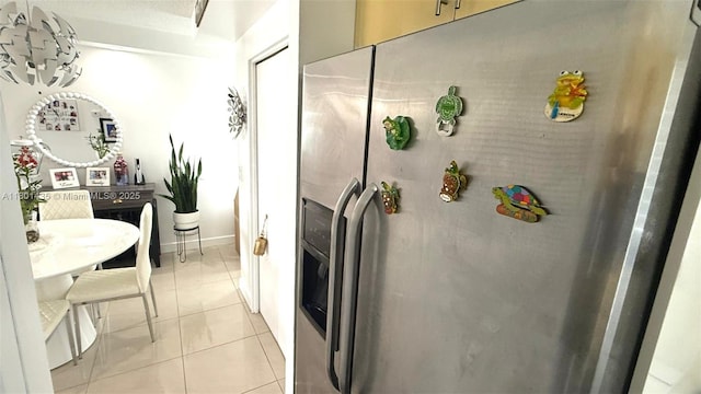 kitchen with stainless steel refrigerator with ice dispenser and light tile patterned floors