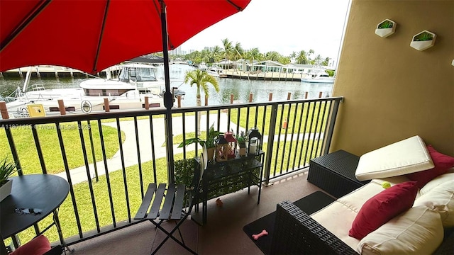 balcony with a water view and a boat dock