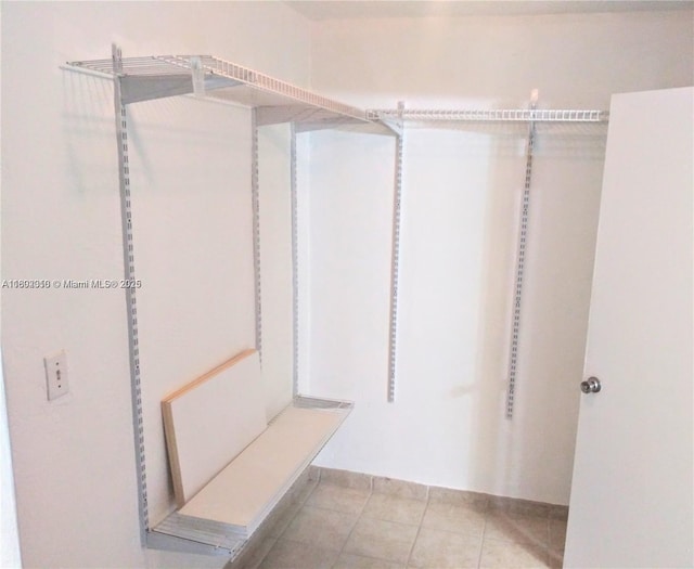 walk in closet featuring tile patterned flooring