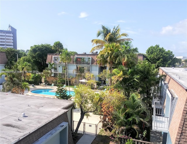 community pool featuring a patio and fence