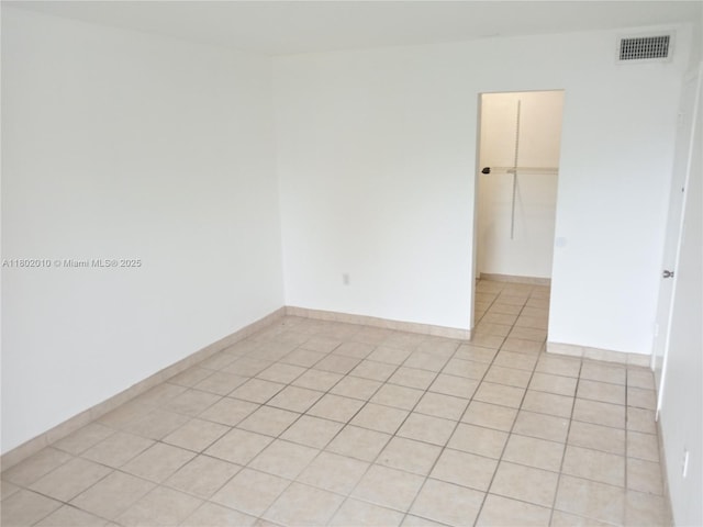 9631 SW 77th Ave Unit 303C, Miami, FL 33156 - spare room featuring light tile patterned floors and baseboards