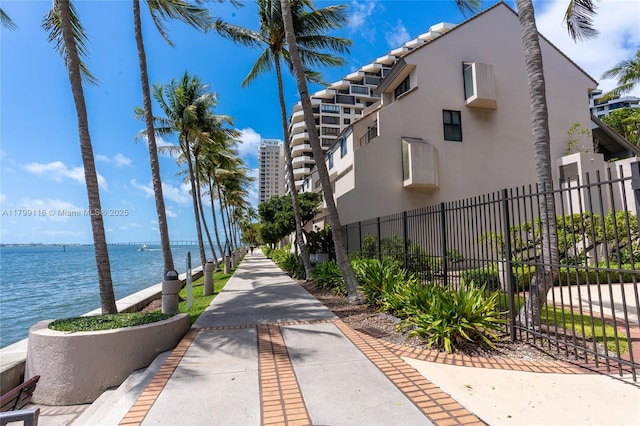 surrounding community featuring fence and a water view
