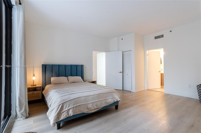bedroom featuring wood finished floors and a closet