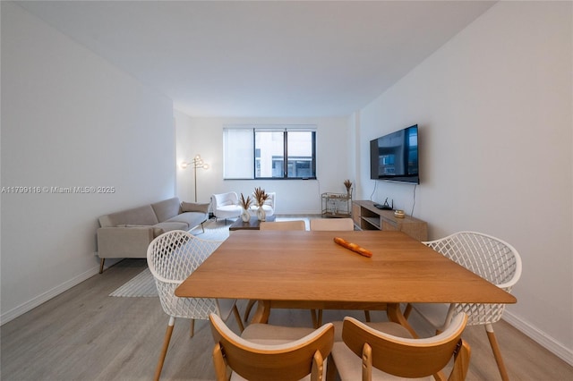 dining room with light wood-style floors and baseboards