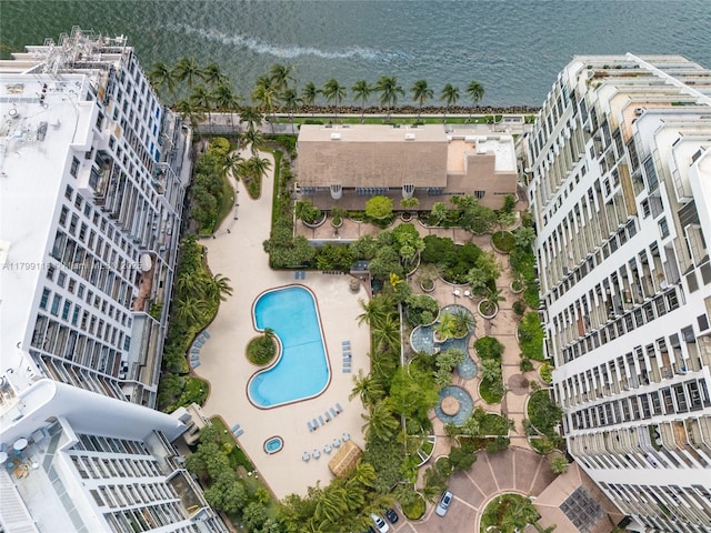 view of property location with a pool area and a nearby body of water