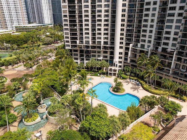 community pool featuring a patio area and a view of city