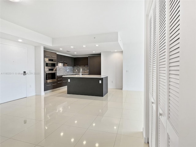 7875 NW 107th Ave Unit 306, Doral, FL 33178 - kitchen featuring modern cabinets, light tile patterned floors, backsplash, dark brown cabinets, and recessed lighting