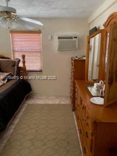 bedroom with an AC wall unit and tile patterned floors
