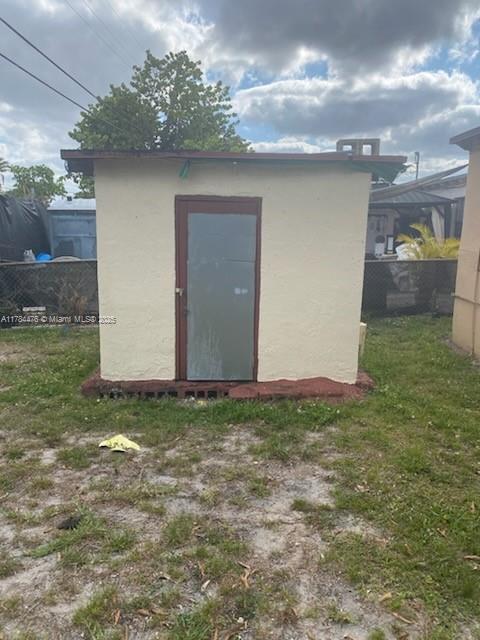 view of shed featuring fence