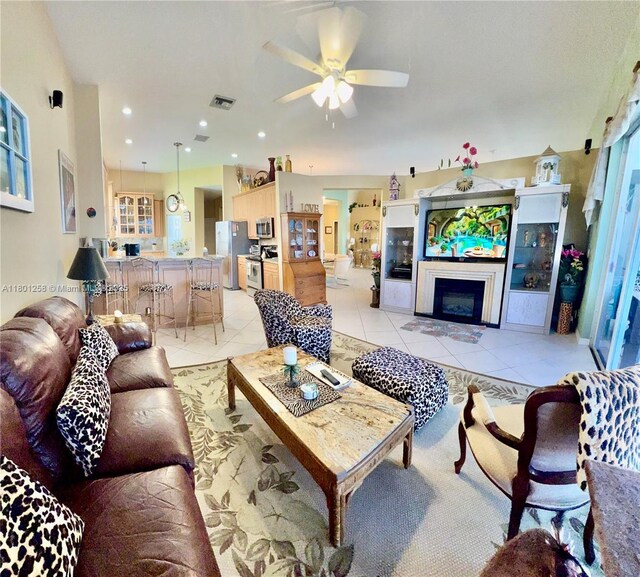 16343 Segovia Cir S, Pembroke Pines, FL 33331 - living area featuring light tile patterned floors, a ceiling fan, a fireplace, plenty of natural light, and recessed lighting