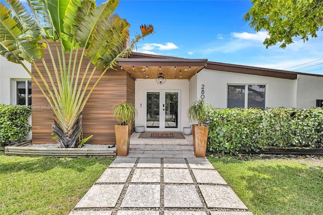 2801 SW 64th Ave, Miami, FL 33155 - doorway to property featuring french doors, stucco siding, and a lawn