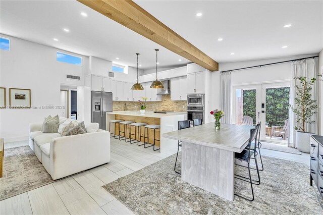 2801 SW 64th Ave, Miami, FL 33155 - kitchen with wall chimney range hood, appliances with stainless steel finishes, a kitchen breakfast bar, french doors, and recessed lighting