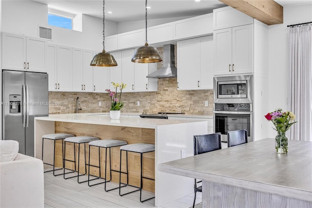2801 SW 64th Ave, Miami, FL 33155 - kitchen featuring wall chimney range hood, appliances with stainless steel finishes, light countertops, backsplash, and recessed lighting