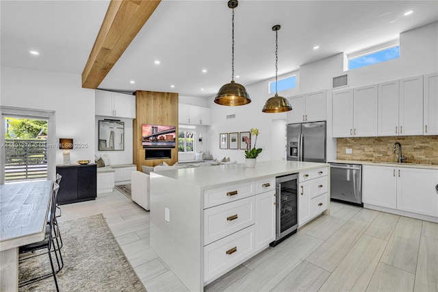2801 SW 64th Ave, Miami, FL 33155 - kitchen featuring beverage cooler, appliances with stainless steel finishes, tasteful backsplash, open floor plan, and recessed lighting