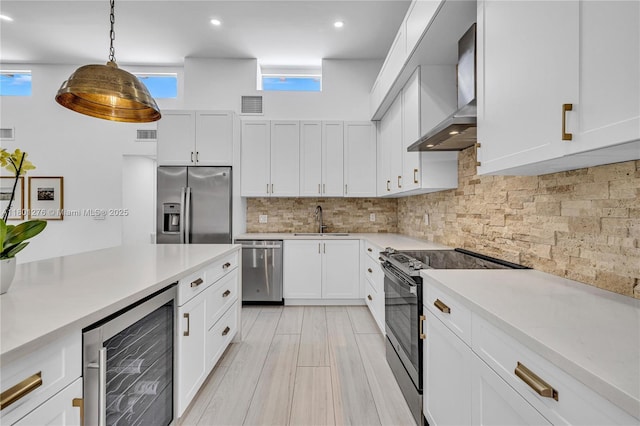 2801 SW 64th Ave, Miami, FL 33155 - kitchen with stainless steel appliances, wine cooler, wall chimney exhaust hood, light countertops, and recessed lighting