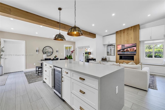 2801 SW 64th Ave, Miami, FL 33155 - kitchen featuring wine cooler, light countertops, white cabinetry, beamed ceiling, and recessed lighting