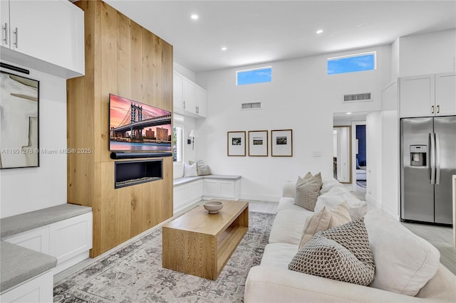 2801 SW 64th Ave, Miami, FL 33155 - living room with a towering ceiling, light wood-type flooring, recessed lighting, and baseboards