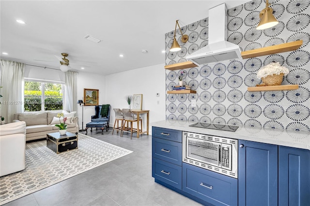 2801 SW 64th Ave, Miami, FL 33155 - kitchen with premium range hood, stainless steel microwave, open shelves, black electric cooktop, and blue cabinets